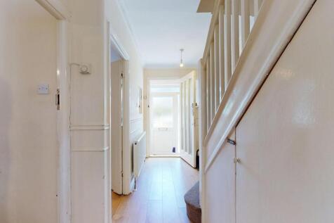 Bright and clean hallway with light-colored wal...