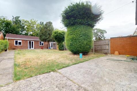 A spacious and well-maintained garden area feat...