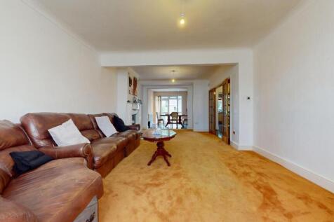 A spacious living room featuring a large brown ...