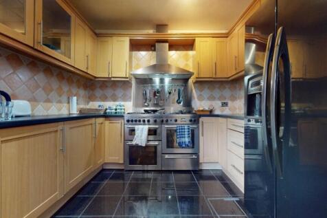 Modern kitchen with wooden cabinetry, stainless...