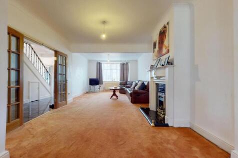 Spacious living room with warm carpeting and a ...