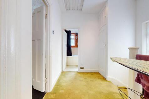 A bright and tidy hallway with clean white wall...