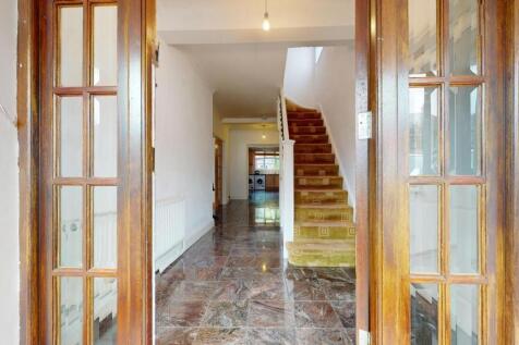 Bright hallway featuring glossy tiled floors an...