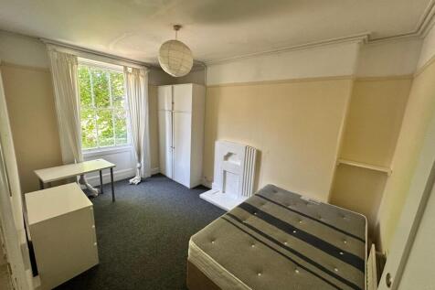 A spacious and bright double bedroom featuring ...
