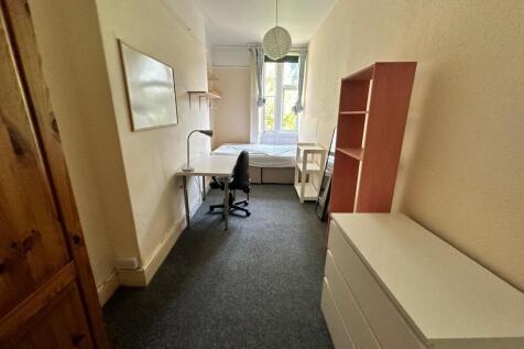 A bright and tidy double bedroom featuring a st...