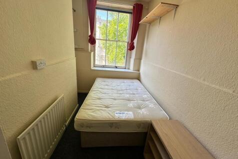 A bright and cozy double bedroom featuring ampl...