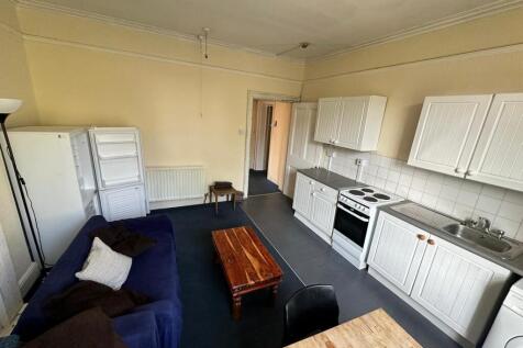 A spacious and tidy kitchenette with ample stor...