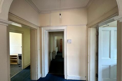 A spacious and tidy hallway with potential for ...