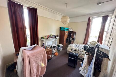 A cozy double bedroom featuring ample natural l...