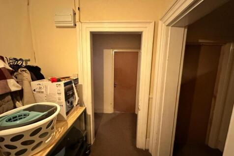 A spacious hallway featuring well-maintained wa...