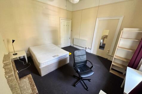 A spacious and well-lit double bedroom, perfect...