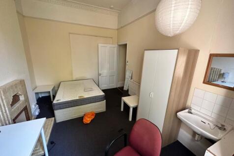 A spacious and inviting double bedroom featurin...