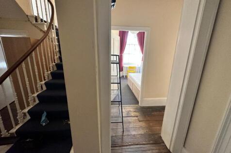 A spacious and inviting hallway with natural li...