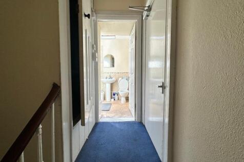 A clean and well-maintained hallway leading to ...