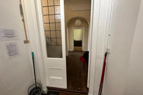 A well-maintained hallway leading to inviting s...