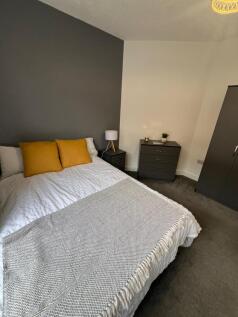 A stylish double bedroom featuring a comfortabl...