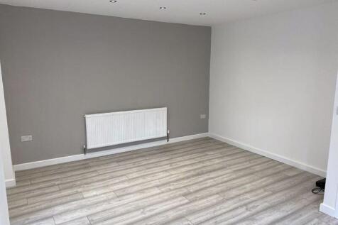 A clean and modern living room featuring light ...