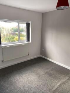 A bright and clean single bedroom featuring a l...