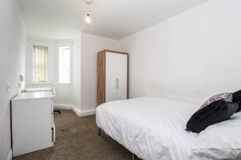 Bright and cozy single bedroom featuring a comf...