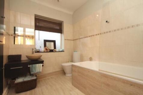 Bright and modern bathroom featuring a stylish ...