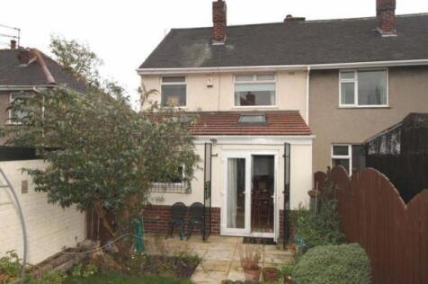 A well-maintained garden area featuring a paved...