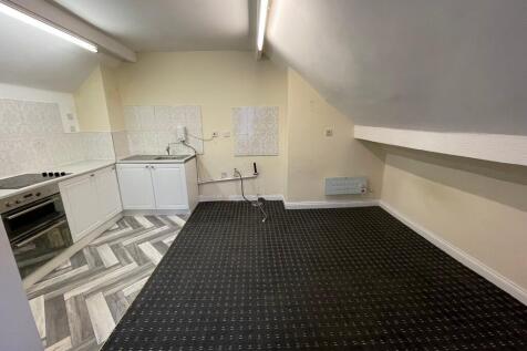 A compact and clean kitchen area featuring mode...