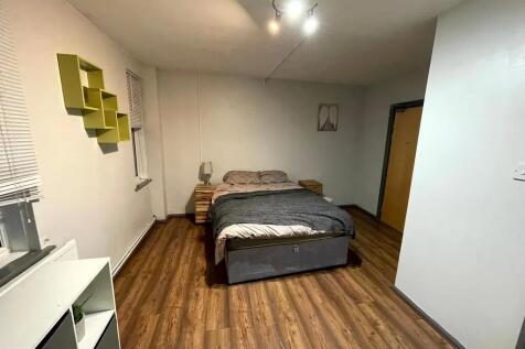 A tidy and spacious double bedroom with warm wo...