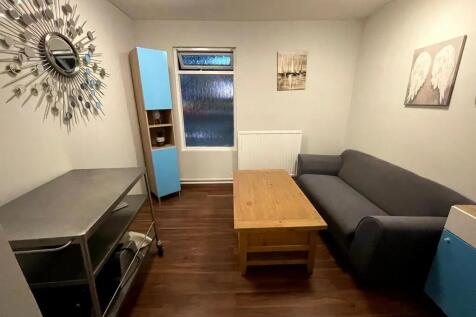 A neat and cozy living room featuring a comfort...