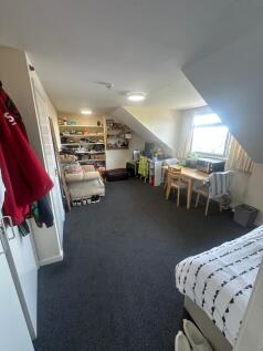 A spacious and well-organized master bedroom fe...