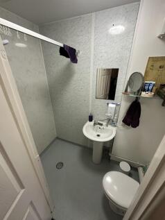 A tidy and functional bathroom equipped with es...