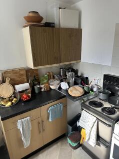 A cozy kitchenette with essential appliances an...