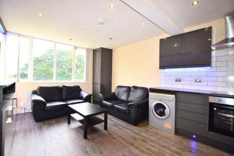 A modern living room featuring two black leathe...