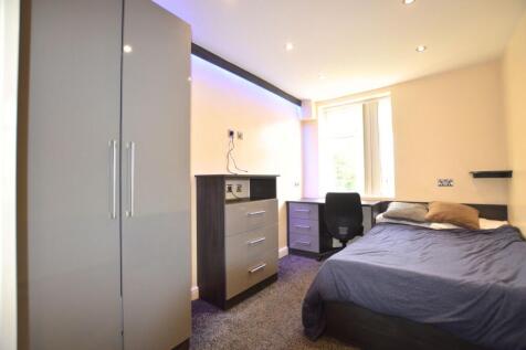 A modern double bedroom with a cozy bed, ample ...