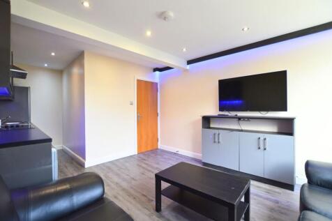 A modern living room featuring sleek black leat...