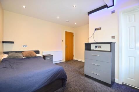 A neat and modern double bedroom featuring a co...