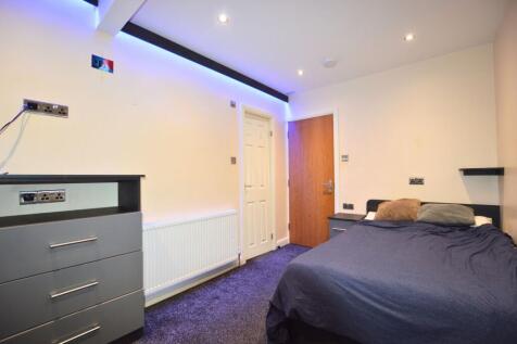 A comfortable double bedroom featuring a neatly...