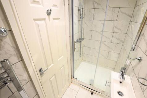 A modern bathroom featuring elegant marble-effe...