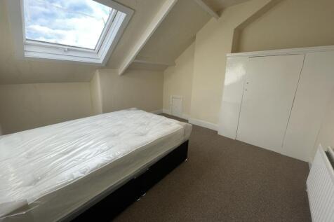 A spacious double bedroom with a large skylight...
