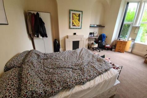 A spacious and bright master bedroom featuring ...