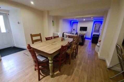 A spacious living and dining area featuring a l...