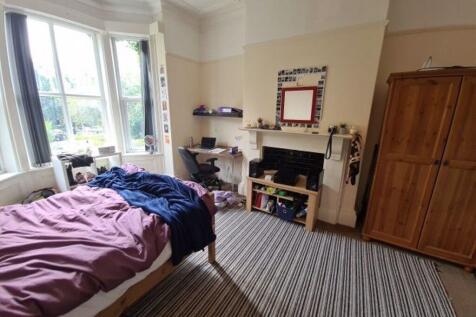 A bright and welcoming double bedroom featuring...