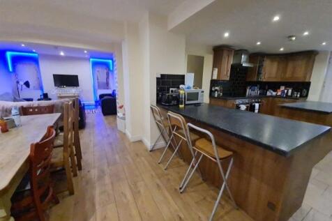 A spacious, modern kitchen featuring a large is...