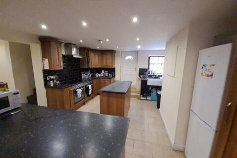 A modern kitchen featuring ample countertop spa...