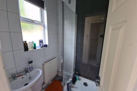 A modern bathroom featuring a clear glass showe...