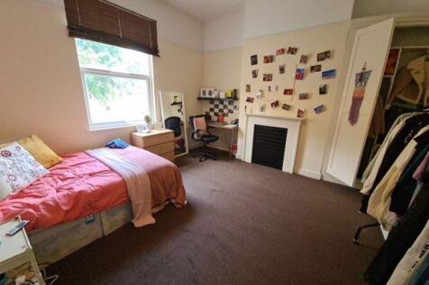 Bright and cozy single bedroom featuring a comf...