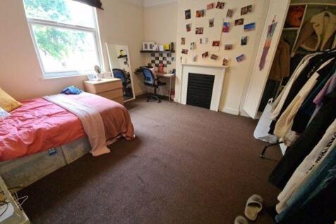 Cozy single bedroom featuring a comfortable bed...