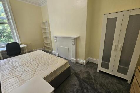 A welcoming double bedroom featuring a double b...