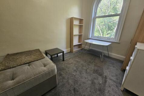 Cozy living room with a comfortable sofa, a sma...