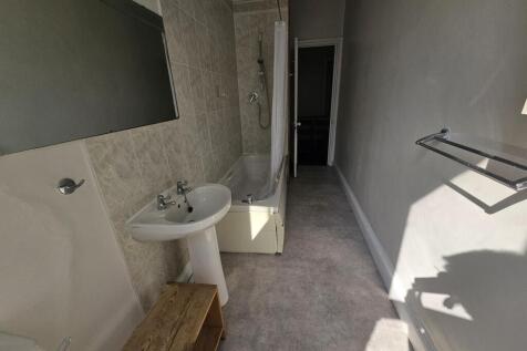 A clean, well-maintained bathroom with a sink, ...