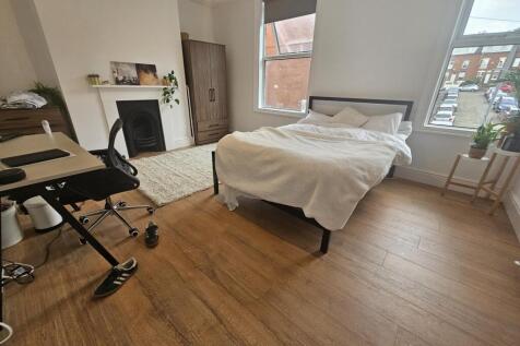 Bright and spacious master bedroom featuring a ...